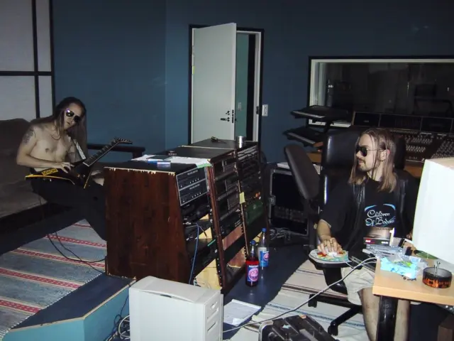A rare photo from 2001 of Alexi Laiho and producer Anssi Kippo at Astia-studio A recording the Aces High and Silent Scream covers! 🤘🤘🤘
 
Alexi is playing his Jackson Custom Shop ”Stryper” that has the ”Wild Child” sticker on it. Anssi seems to be drinking raspberry lemonade. If you have seen the Alexander Kuoppala interview on The Early Years of Children of Bodom – 30 Years of Astia-studio, you’ll know what those very cool sunglasses were called among the Bodom camp. 😎
 
These cover versions, as well as the Hate Me! single and the Hate Crew Deathroll album were recorded through the legendary Helios mixing console preamps. The desk can be seen at the back of the control room. 🎚🎛
 
Once Anssi completed the recording and mixing, they went to perform first at the Midnight Party Planet festival in Kouvola, and the next day it was Nummirock in Kauhajoki. Were you at one of those gigs, and if so, how did you like it? ⭐️

@cobhc @alexilaiho.official @officialjacksonguitars 

#childrenofbodom #cobhc #alexilaiho #anssikippo #astiastudio