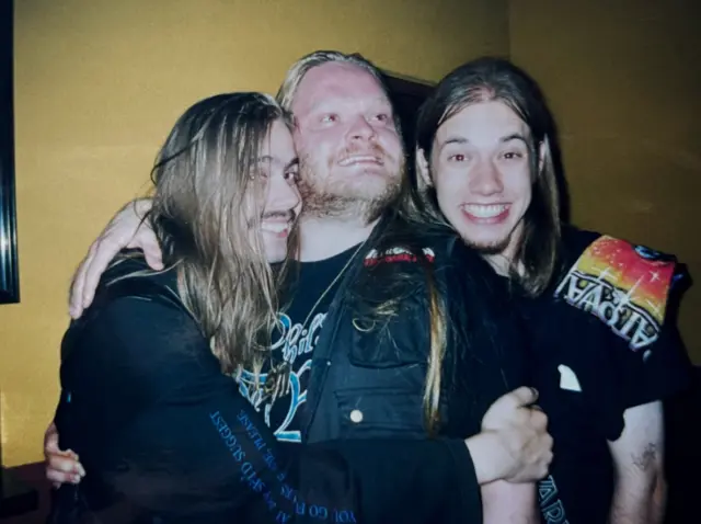 Alexander Kuoppala, Janne Wirman, and COB’s FOH sound engineer/producer Anssi Kippo having a group hug in 2002! ⭐️
 
Janne seems super happy as he had just gotten a Stratovarius Destiny World Tour 98/99 T-shirt. Alexander is looking at the bright future, while Anssi’s holding on to him tightly. 😅
 
This photo may have been taken at Wacken Open Air 2002 or at some other festival around that time. 🤘
 
Metal music is usually made by people who love to laugh and have a blast! 😊👍
 
@cobhc @alexander_kuoppala @janne_wirman 
 
#cob #cobhc #alexanderkuoppala #jannewirman #anssikippo